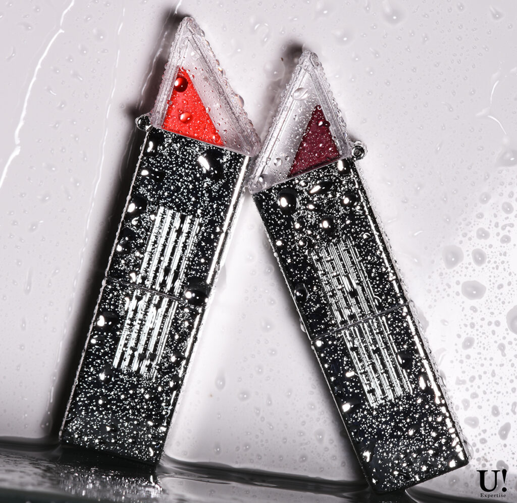 Lipsticks against wet wall with water drops. Photographed by ViaUPhotography in the style used by Glossier.